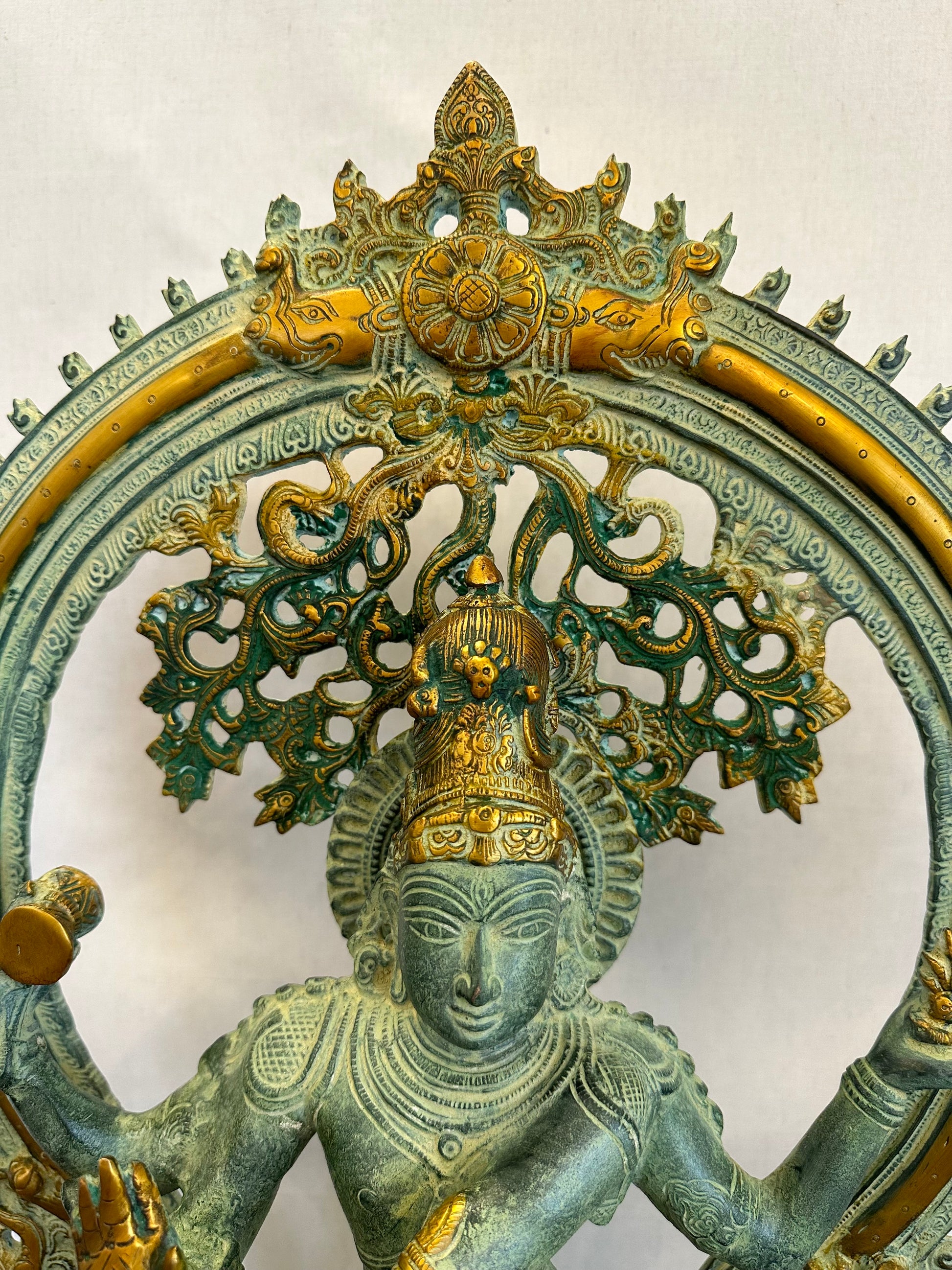 Decorative sculpture of a figure with intricate designs on a white background