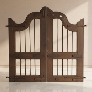 Pair of vintage wooden gates with metal bars on a gray background