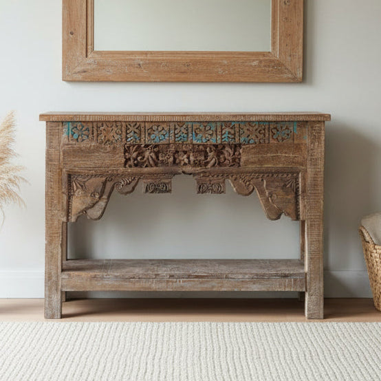 Wooden console table with intricate carvings in a room setting