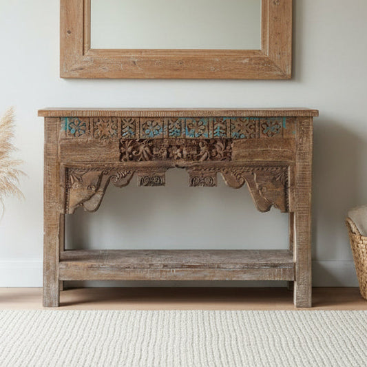 Wooden console table with intricate carvings in a room setting