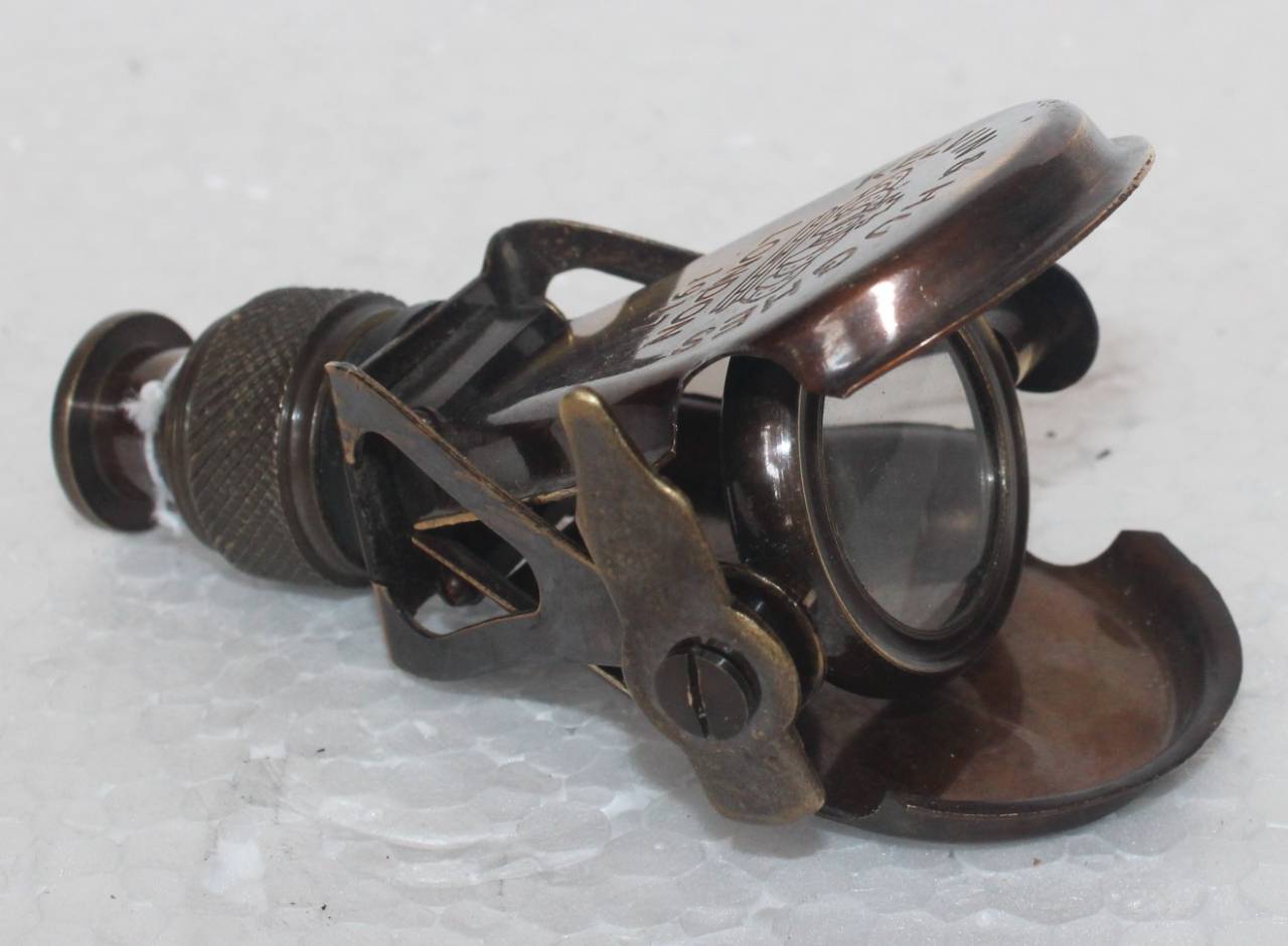 Metallic clip with intricate design on a light gray background