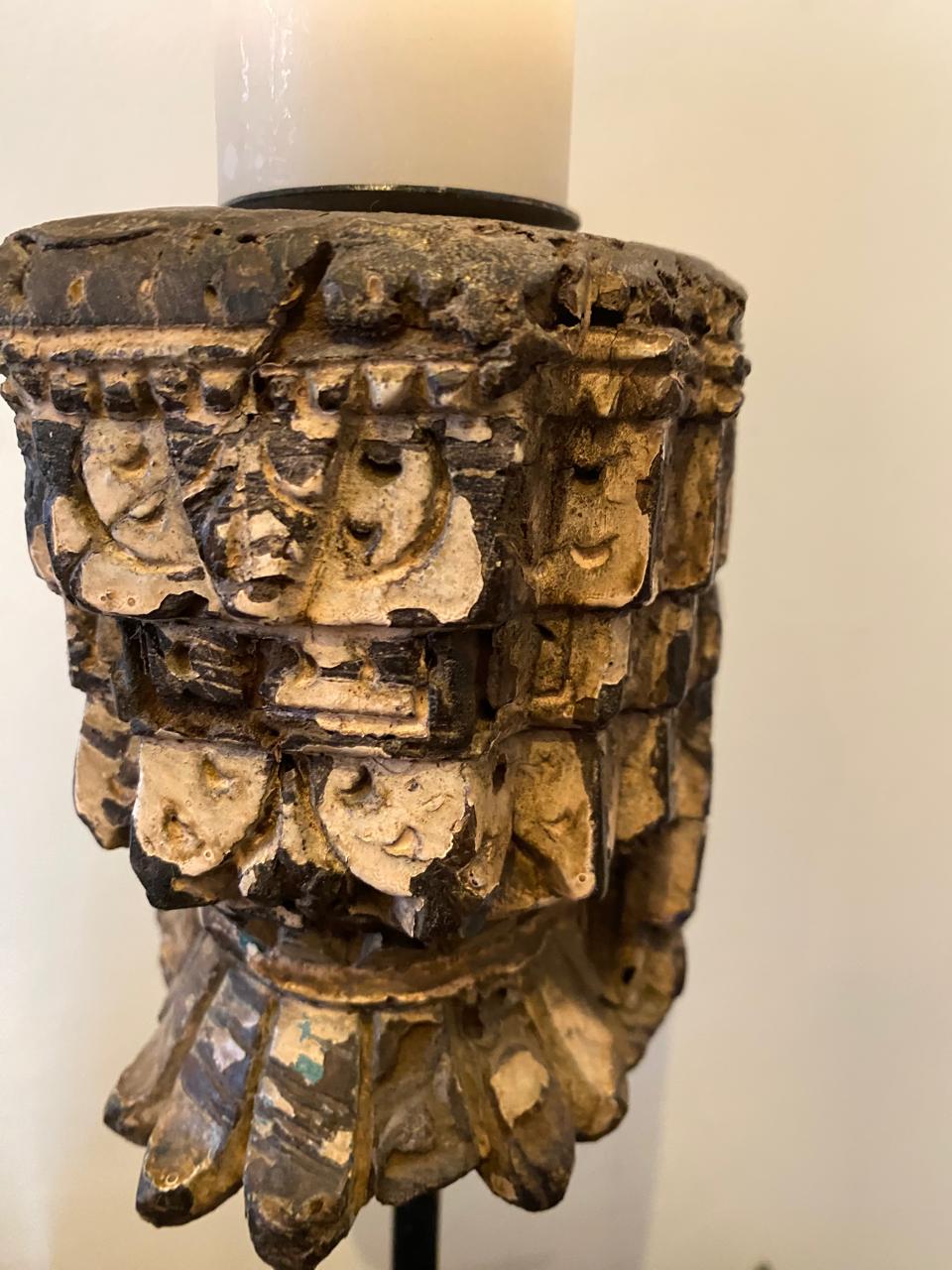 Decorative candle holder with intricate carvings on a white background