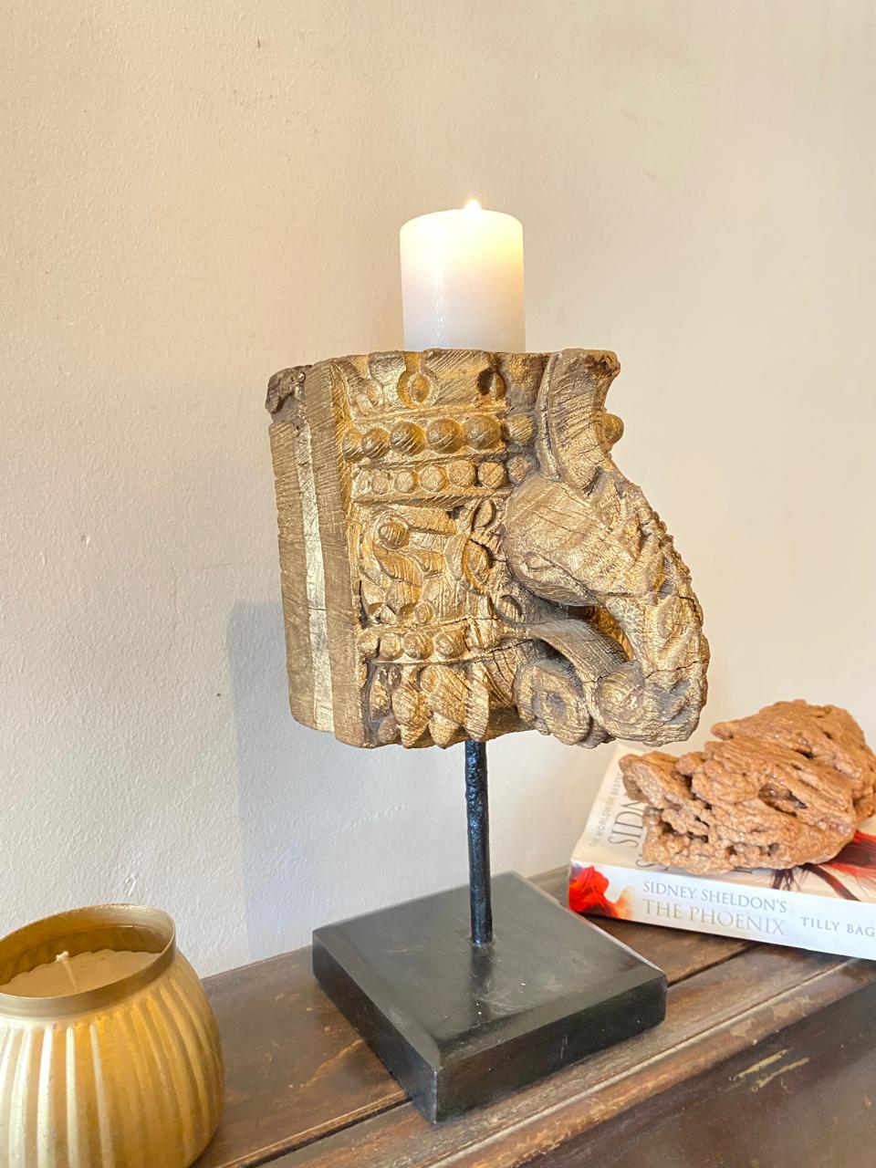 Decorative candle holder with intricate design on a wooden surface.