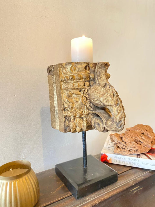 Decorative candle holder with intricate design on a wooden surface.