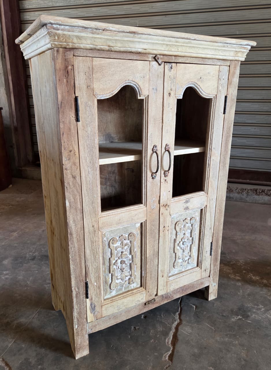Wooden cabinet with glass doors in a rustic setting