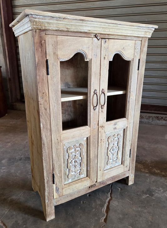Wooden cabinet with glass doors in a rustic setting