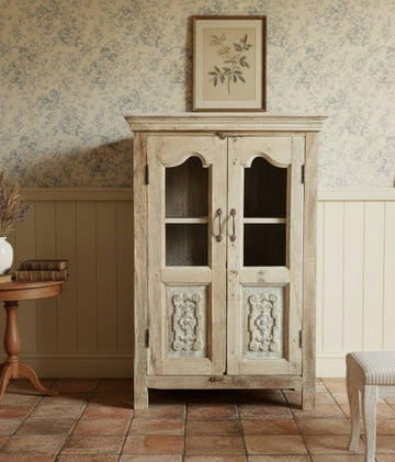 Wooden cabinet with glass doors in a rustic setting