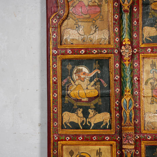 Decorative panel with intricate artwork and colorful borders on a white wall.