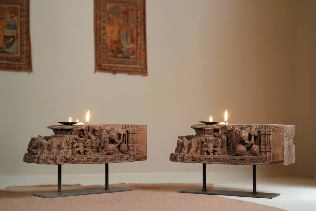 Two rustic wooden candle stand with intricate carvings on a light background