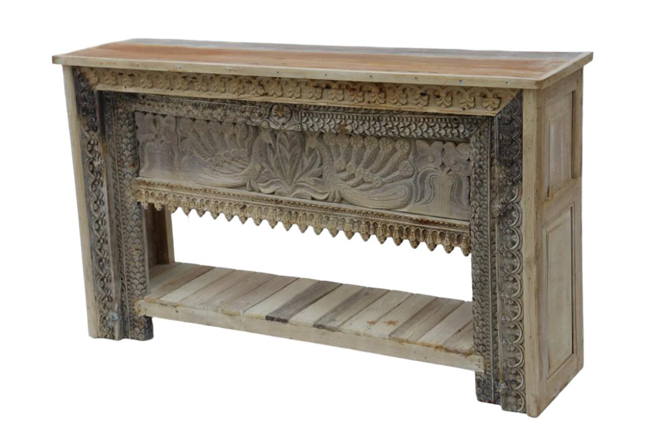 Wooden console table with intricate carvings on a white background