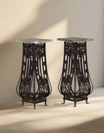 Two ornate metal stands on a neutral background