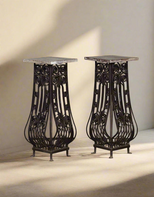 Two ornate metal stands on a neutral background