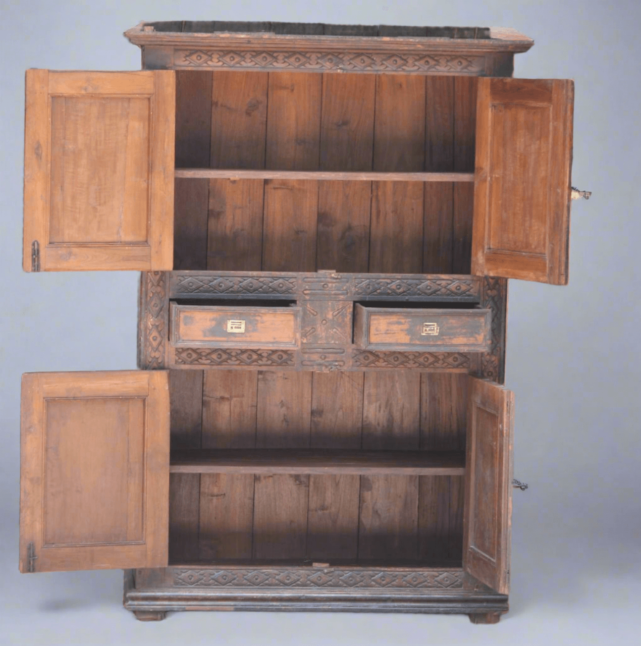 Wooden cabinet with open doors on a gray background