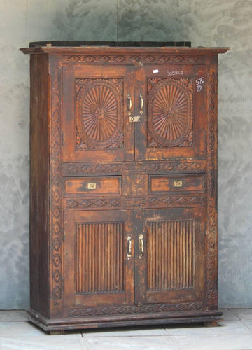 Vintage wooden cabinet with intricate carvings on a gray background