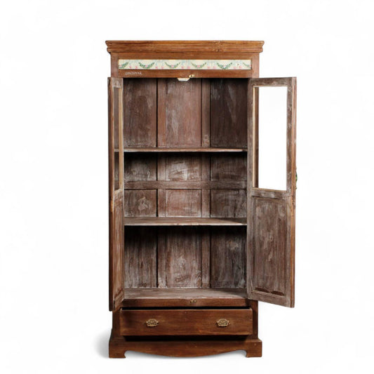 Close-up of wooden glass almirah showing intricate floral carvings and traditional Indian craftsmanship on teak wood