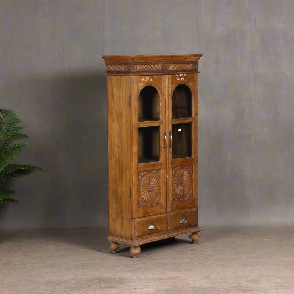 Vintage wooden glass almirah in teak wood with brass accents, floral carvings, 56 inches tall storage cabinet"
