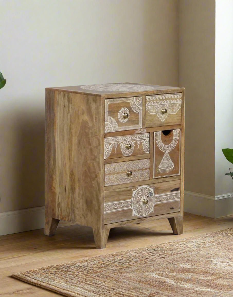 Wooden chest of drawers with decorative elements on a neutral background