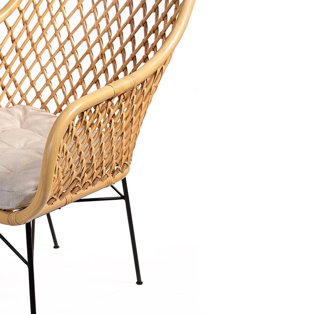 Wicker chair with a cushion on a white background