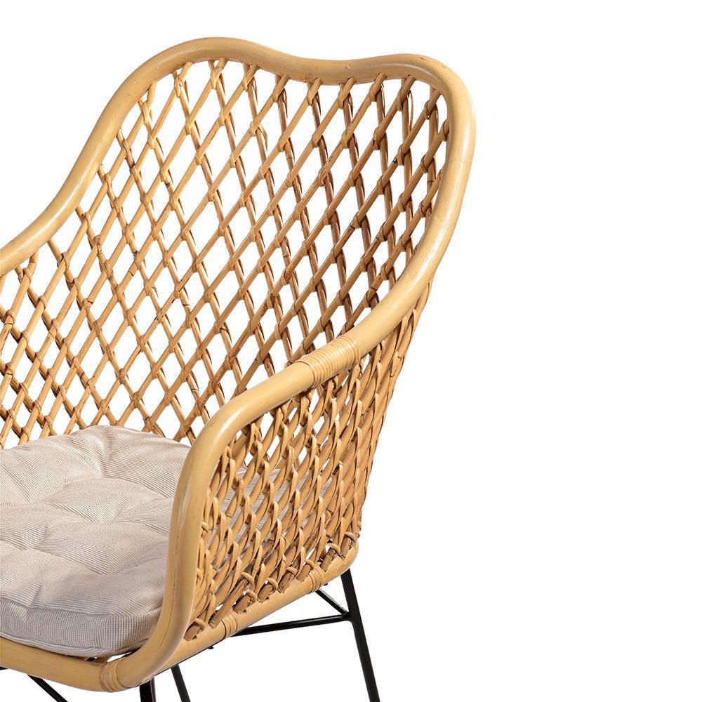 Wicker chair with a cushion on a white background