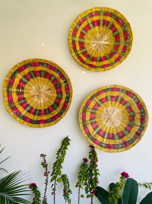 our Bamboo wall hanging is going to make for a fresh addition to the house decor. The exquisite weave design with the floral dyes adds to its vibrant aesthetic. The wall decorator is sure to bring a pop of color and enliven the room settings with the vibrant decor. The handmade basket is eco-friendly, hand-dyed with organic colors and sturdy. Make the most of sustainable home choices with this vibrant set of handcrafted multi-utility baskets. Baskets includes hooks for hanging.