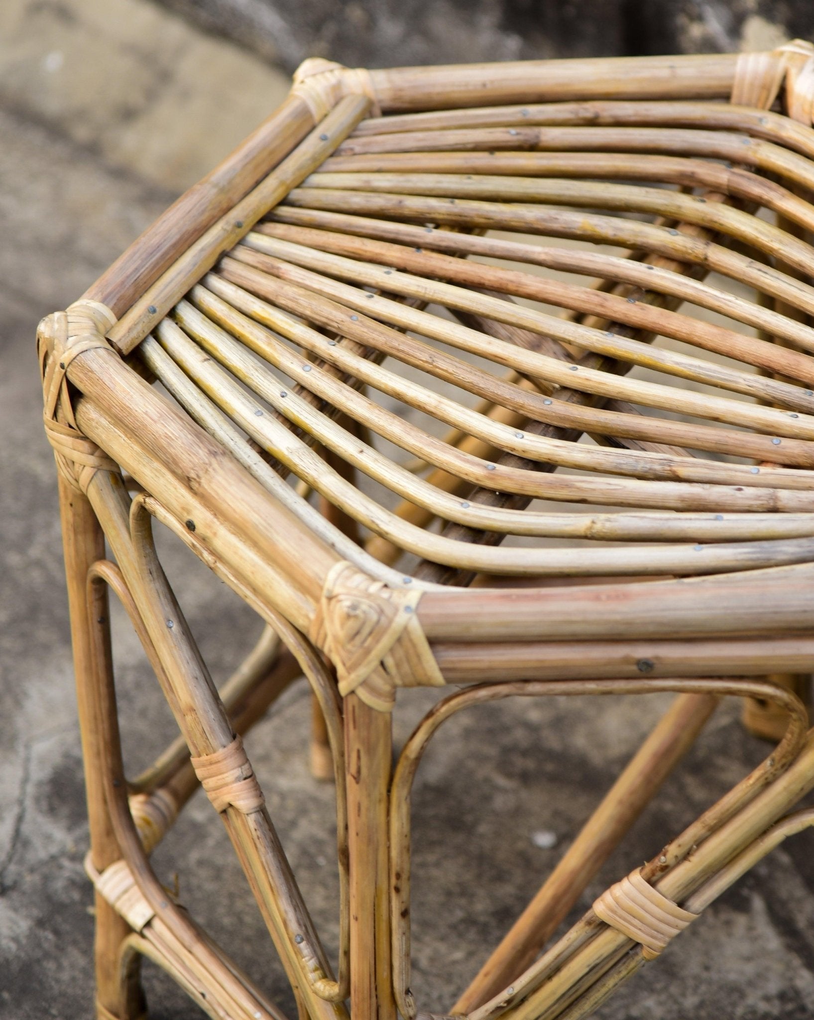 Close-up of a wicker chair with a textured background