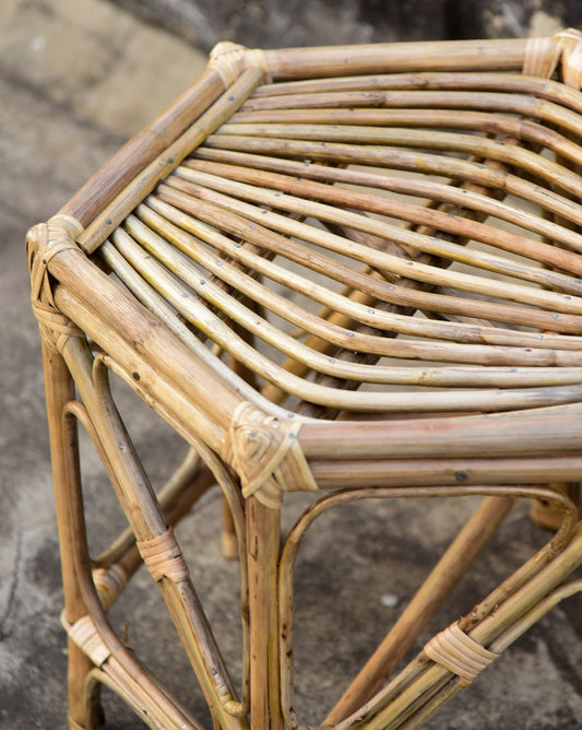 Close-up of a wicker chair with a textured background